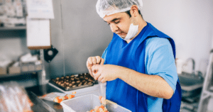 Someone working in a kitchen preparing food.