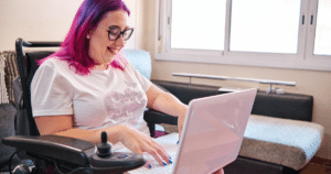 A woman in a wheelchair working on a laptop